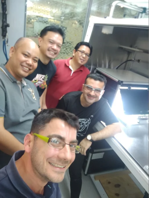 Installation team beside an ARKEO laboratory system