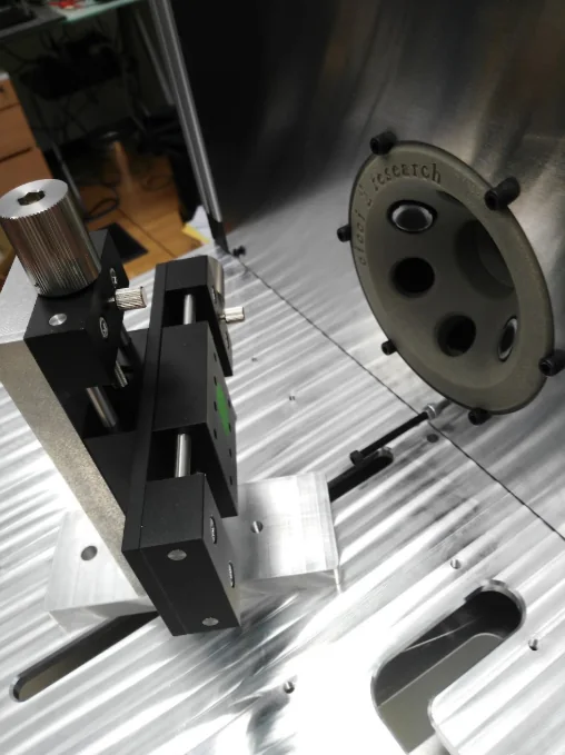 Close-up of an optical access port and positioning hardware inside an ARKEO enclosure